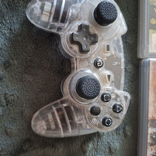 PlayStation 3 games pack with 7 titles and transparent controller like new