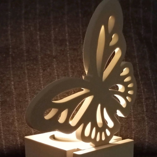 Decorative candle holder with butterfly design in white porcelain powder