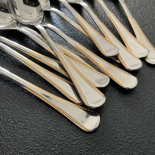 Tray with 12 unused 18/8 stainless steel Amefa dessert spoons like new