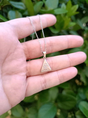 Minimal handmade steel chain necklace with a triangle pendant featuring a carved eye