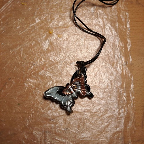 Butterfly necklace like new with liquid glass and rubber cord