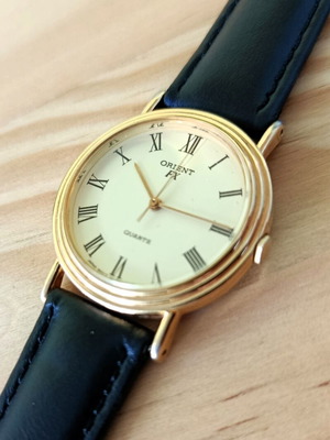 Orient FX vintage quartz watch with gold tone case and black leather strap