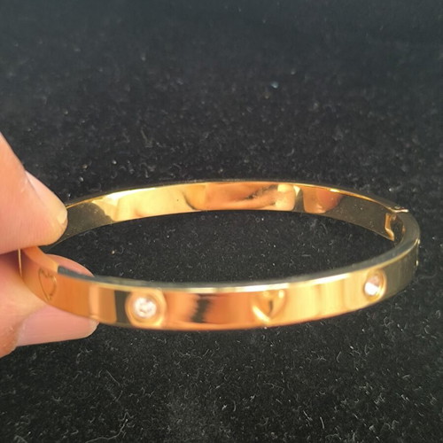 Gold Tone Bangle Bracelet with Hearts and Crystal Details new