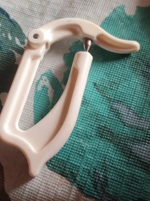 Device for opening holes in baby bottle rubber used