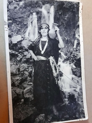 Vintage black and white photo woman with traditional costume and jug used