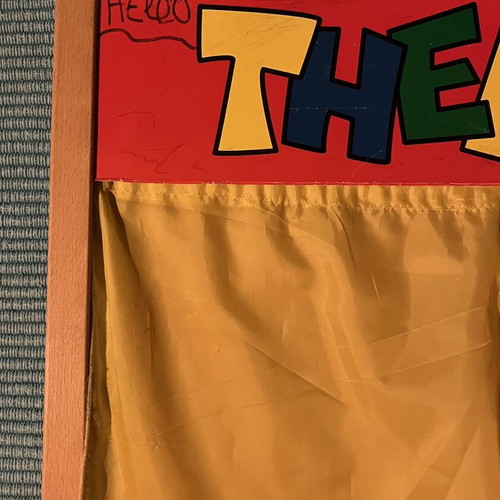 Used puppet theater with wear and missing support side