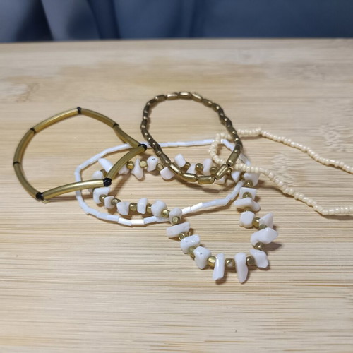 Set of elastic bracelets with assorted beads in black, white and gold