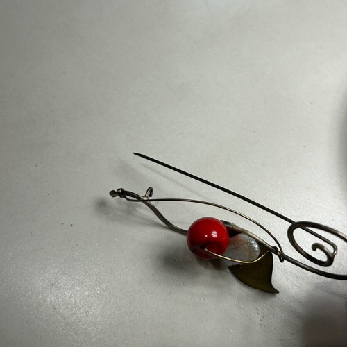 Alternative metal pin used, red and gold colors