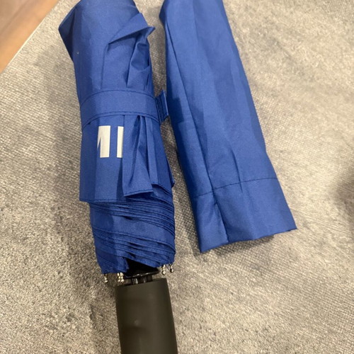 Blue folding umbrella branded with NIKMI AD new