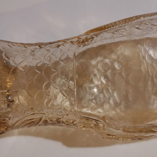 Glass bottle in fish shape used