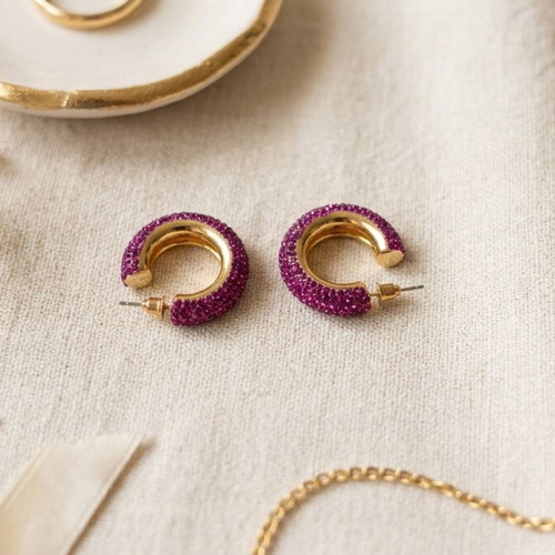 Chunky gold hoop earrings with purple rhinestones, used