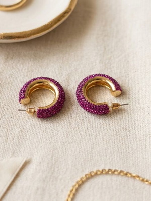 Chunky gold hoop earrings with purple rhinestones, used