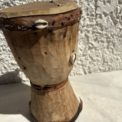Handmade wooden drum used, African style with leather membrane and shells