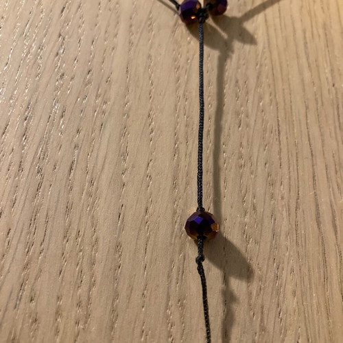 Necklace with purple beads like new, long with black cord