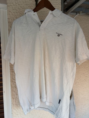 Two white polo shirts used, size XL, slight yellow stain on one