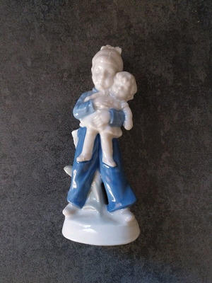 Porcelain figurine new with girl holding doll