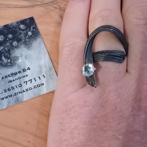 Handmade ring of oxidized silver with white topaz like new