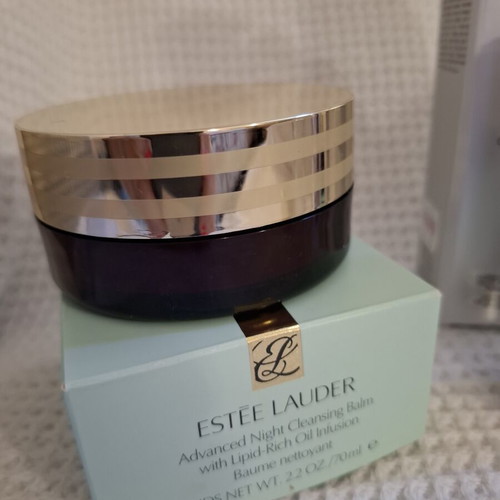 Empty Dior and Estèe Lauder cosmetic jars used, set