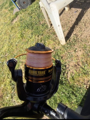 Pregio David 5000 fishing reel used with line and rod holder