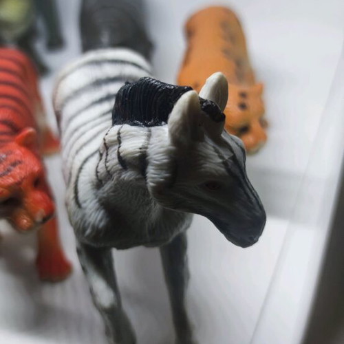 Plastic jungle animals and small dinosaurs used
