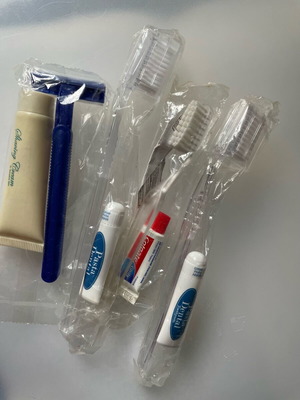 Bathroom products set new, sealed toothbrushes and razor