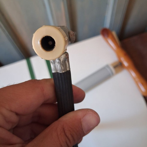 Manual air pump used with wooden handle and flexible hose
