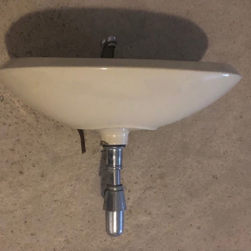 Beige sink used with faucets