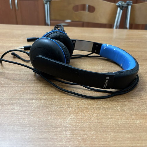 Wired headphones with 5m extension cable used, visible wear on plastic