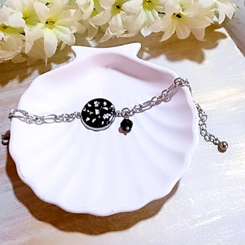 Handmade steel bracelet with iridescent black motif and silver flakes