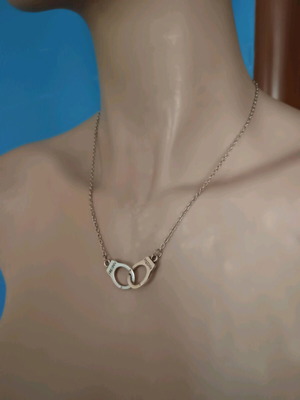 Handcuffs necklace like new, silver zinc alloy