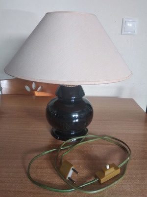 Table lamp used with black glossy base and cream washable shade
