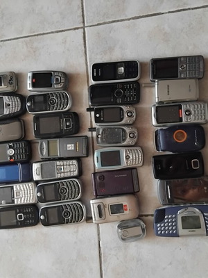 Old mobile phones with chargers and headphones