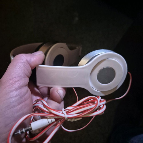 Foldable on-ear headphones used, white with silver details