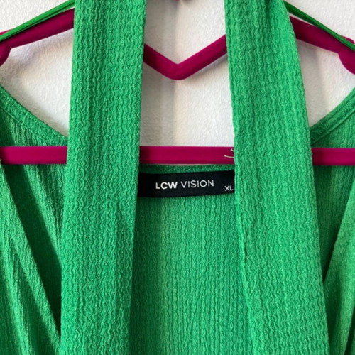 Emerald green one-piece jumpsuit with sleeves and waist belt