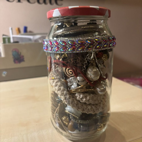 Jar treasure with assorted women's jewelry and accessories