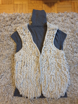 Grey turtleneck top, beige sleeveless fur vest and black stone earrings set