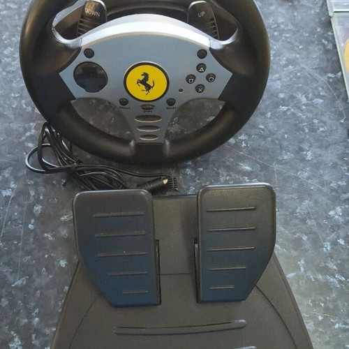 Sony PlayStation 2 console used with Thrustmaster racing wheel and accessories