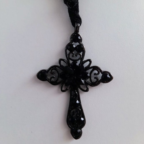 Black metal cross necklace like new with shiny stones on velvet ribbon