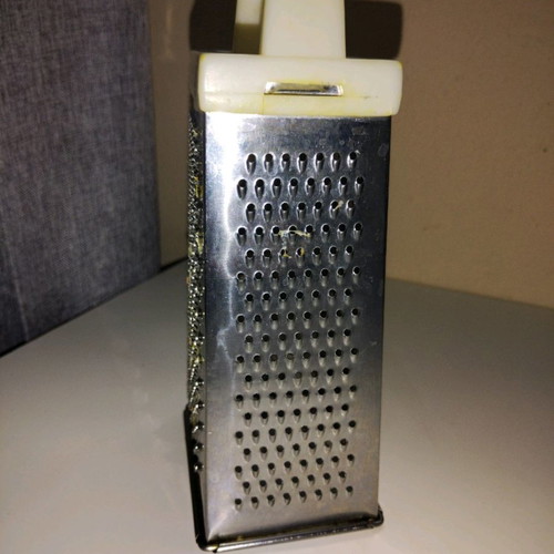 Cheese grater used, stainless steel with plastic handle