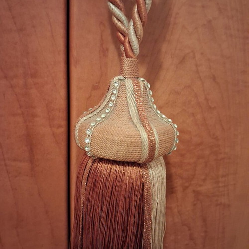 Curtain tieback used, gold-orange color
