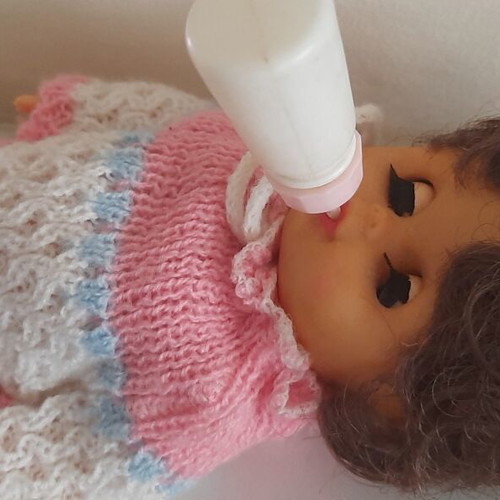 Vintage plastic baby doll from the 70s used with handmade sweater and hat