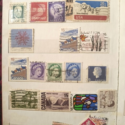Stamp album like new with about 500 mostly foreign stamps