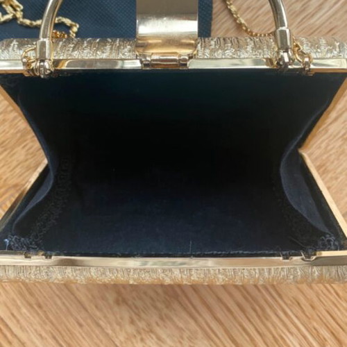 Gold clutch bag with chain strap