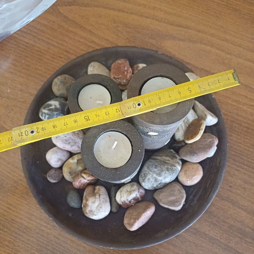 Decorative table set with stones and candles, new