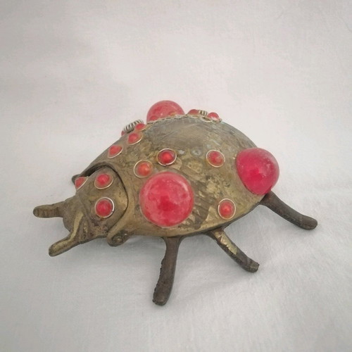 Bronze ashtray used with red scarab-shaped stones