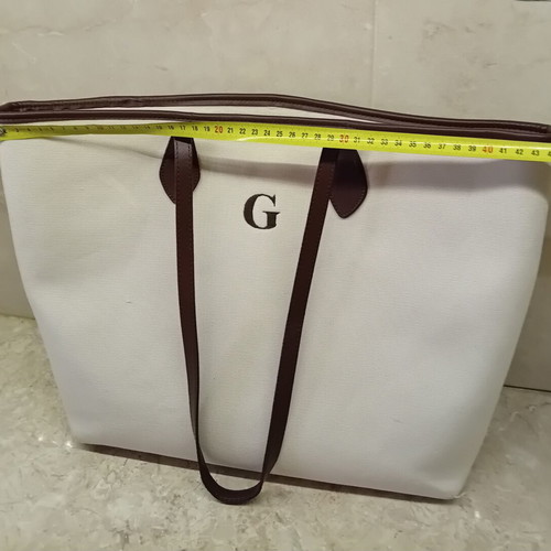 Large beige fabric shoulder bag with brown leather details
