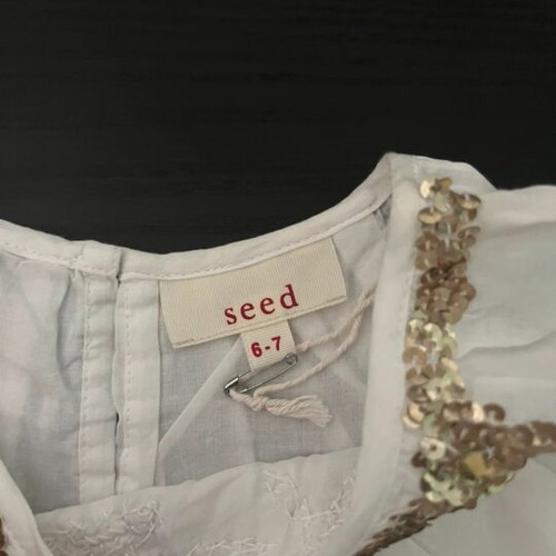 White blouse with gold details