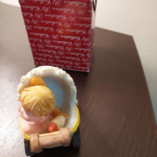Decorative collectible baby stroller with baby and bottle like new