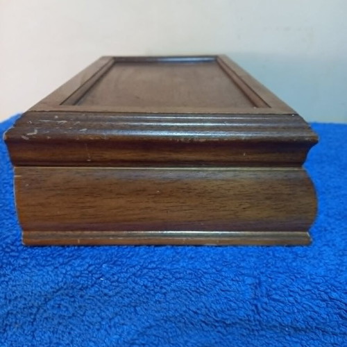 Wooden jewelry box used with velvet-lined compartments