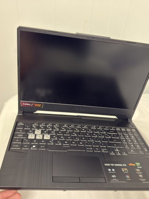 Asus TUF A15 gaming laptop with charger and Razer mouse